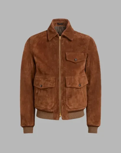 Detailed look at the pockets and zipper closure on Eddie Redmayne’s brown suede jacket in The Day of the Jackal.