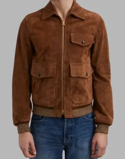 Eddie Redmayne wearing the iconic brown suede jacket in The Day of the Jackal series.