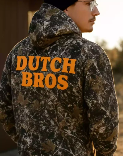 Close-up detailed shot of a festive white mug featuring holly leaves and red berries, styled for winter and holiday décor.