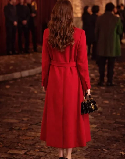 emily-in-paris-red-coat-back-view Back view of Emily in Paris red coat season 4 worn by Lily Collins, featuring a long red trench coat Emily in Paris style with a refined emily long coat silhouette.