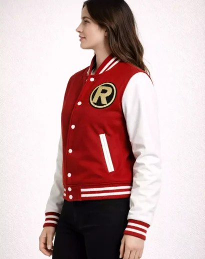 Side profile of woman wearing red and white varsity jacket with striped ribbed collar