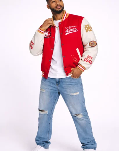 golf-wang-49ers-letterman-jacket-full-body-red-varsity Full body model wearing Golf Wang 49ers letterman jacket, red letterman jacket men styled with jeans
