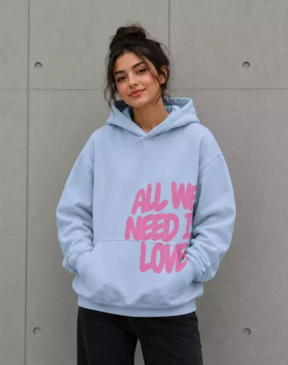 Young woman wearing all we need is love hoodie blue oversized casual hoodie front side trendy outfit