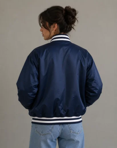 Blue bomber jacket women back view featuring Vintage New York Yankees Starter Jacket inspired design, vintage blue yankees jersey aesthetic with retro MLB fashion appeal.