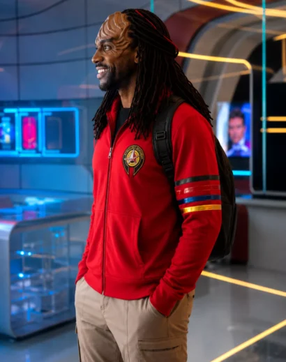 Left profile view of the Karim Diane Star Trek hoodie, showcasing the detailed academy patch, striped sleeve accents, and comfortable Starfleet Academy jacket styling in a vibrant Karim Diane red hoodie design.