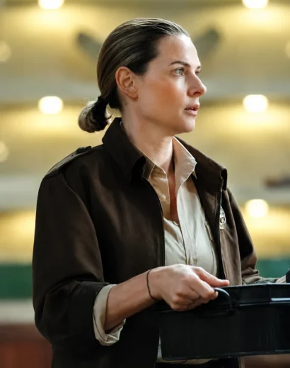 Rebecca Ferguson wearing the Juliette Nichols Silo S01 Brown Cotton Jacket over a Rebecca Ferguson cotton shirt, completing the iconic Rebecca Ferguson Silo outfit with a timeless women brown jacket style.