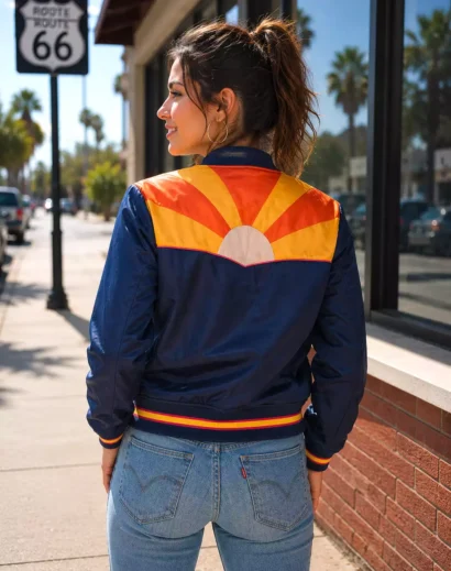 Back view of women’s retro sunset bomber jacket with orange yellow sunburst design