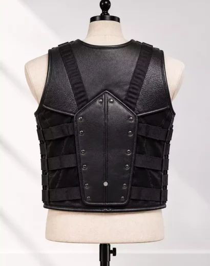 Back view of a men's black leather combat vest showing the textured central back panel, rivet detailing, adjustable side straps and reinforced shoulder harness.