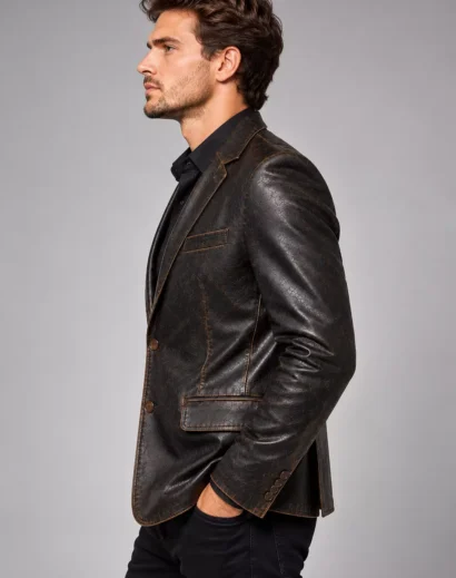 mens-distressed-leather-blazer-left-side Left side view of a men's distressed leather blazer showcasing the fitted silhouette and textured leather sleeves