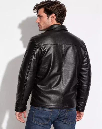 mens-premium-black-leather-jacket-back-view-classic-fit Men's premium black leather jacket back view featuring a classic collar, structured shoulder seams, detailed stitching, smooth textured leather and a modern regular fit.
