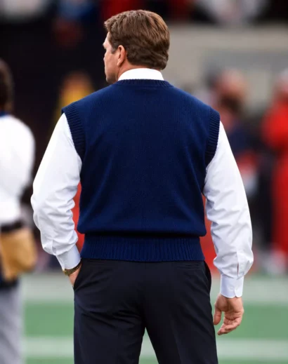 navy-knit-sweater-vest-back Back view of a navy blue sleeveless knit sweater vest with ribbed neckline, armholes, and hem.